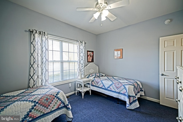 bedroom with ceiling fan, baseboards, and dark colored carpet