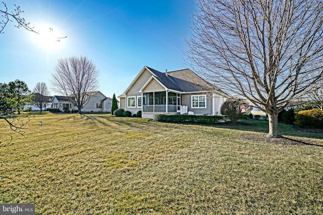 view of front facade featuring a front yard and a sunroom