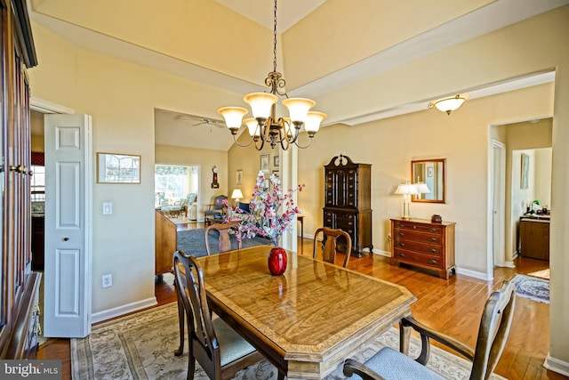 dining room with an inviting chandelier, baseboards, and hardwood / wood-style flooring