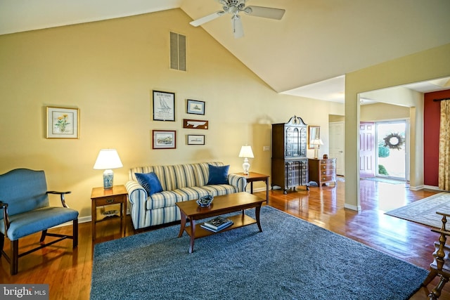 living room with visible vents, a ceiling fan, wood finished floors, high vaulted ceiling, and baseboards