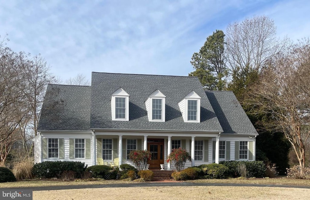 new england style home with a porch