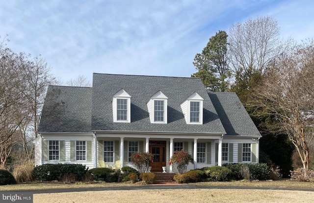 cape cod-style house with covered porch