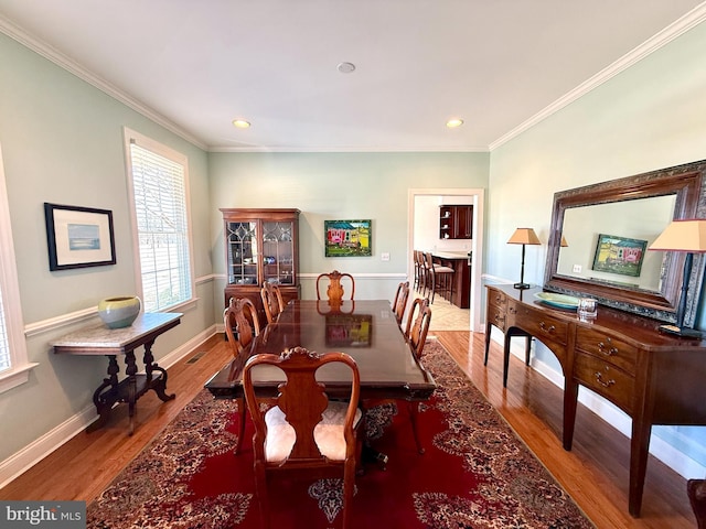 dining space featuring crown molding and wood-type flooring