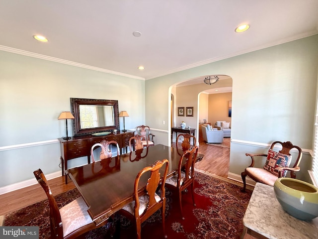 dining room featuring ornamental molding and hardwood / wood-style floors