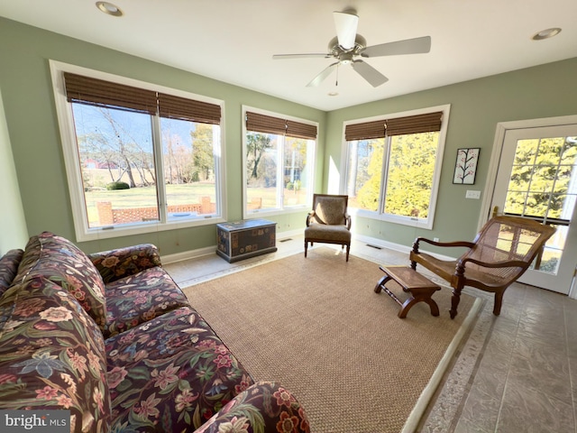 sunroom featuring ceiling fan