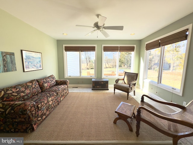 living room featuring light carpet and ceiling fan