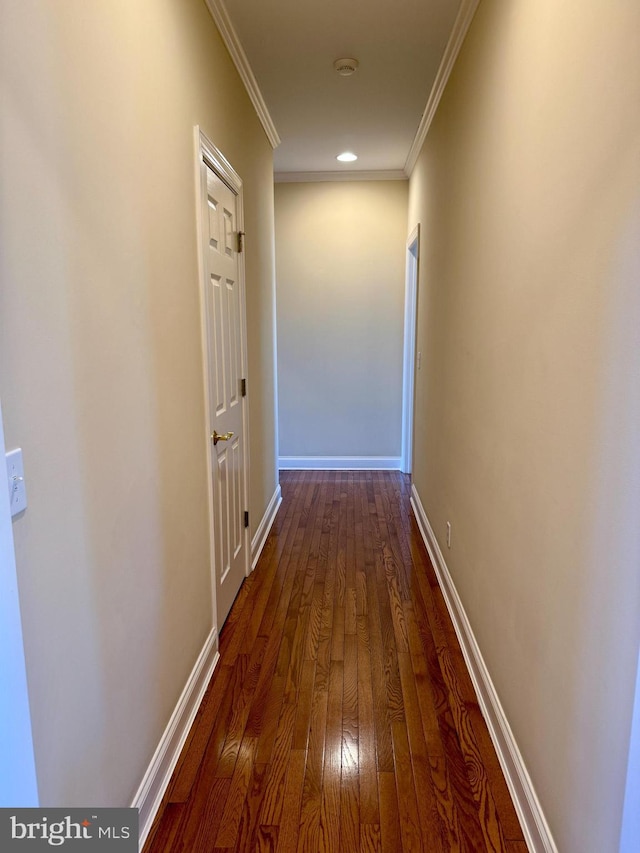 hall featuring ornamental molding and dark hardwood / wood-style flooring