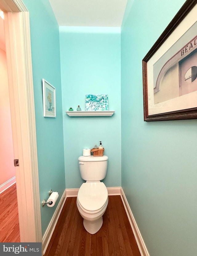 bathroom with toilet and hardwood / wood-style floors