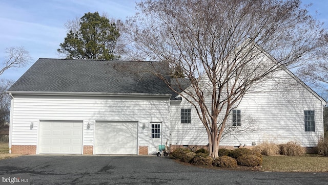 view of side of property with a garage