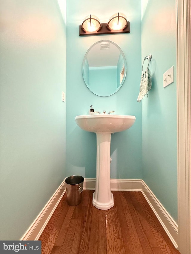 bathroom with hardwood / wood-style floors