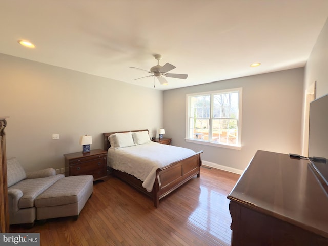 bedroom with ceiling fan and hardwood / wood-style floors