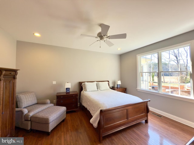 bedroom with ceiling fan and dark hardwood / wood-style flooring