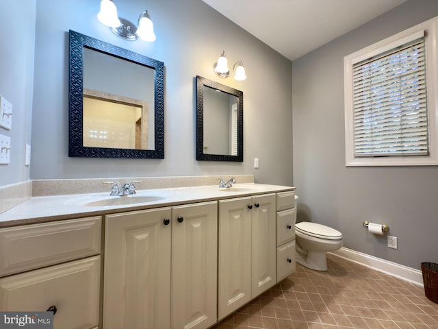 bathroom featuring tile patterned flooring, vanity, and toilet