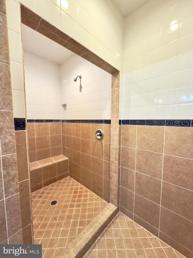 bathroom with a tile shower