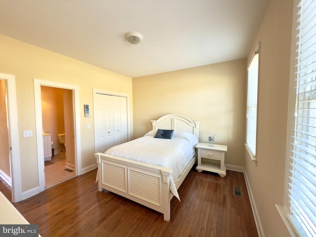 bedroom with a closet and dark hardwood / wood-style floors