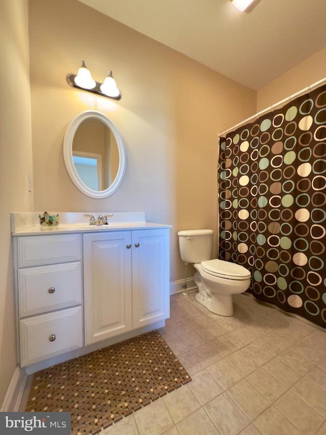 bathroom with vanity, tile patterned floors, and toilet