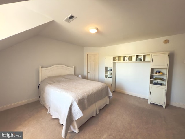 bedroom with vaulted ceiling and carpet