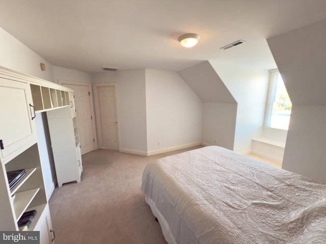 carpeted bedroom with vaulted ceiling