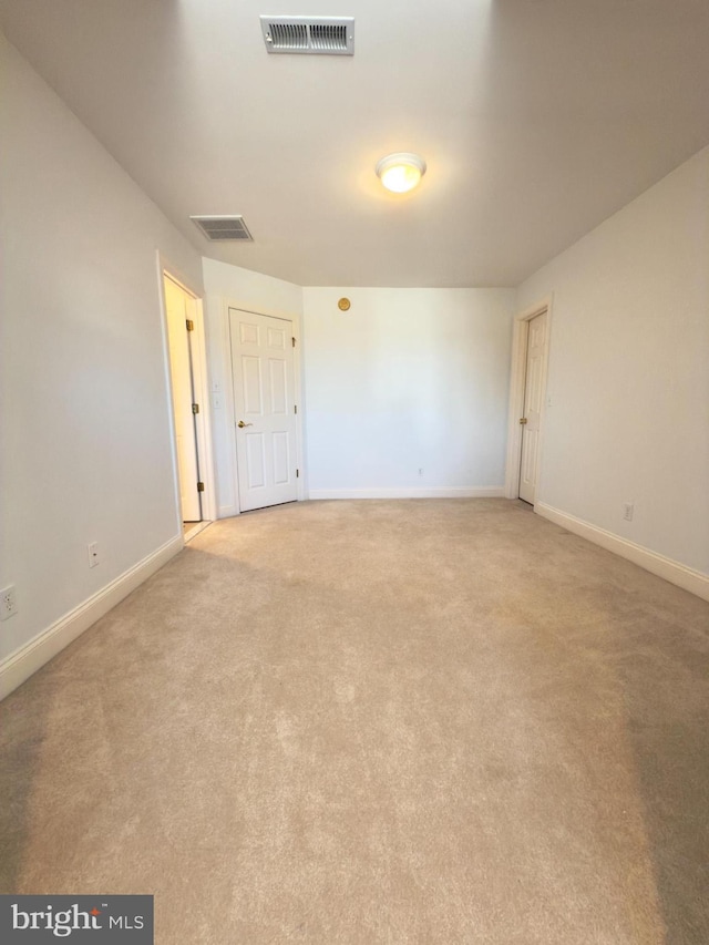 unfurnished room with light carpet