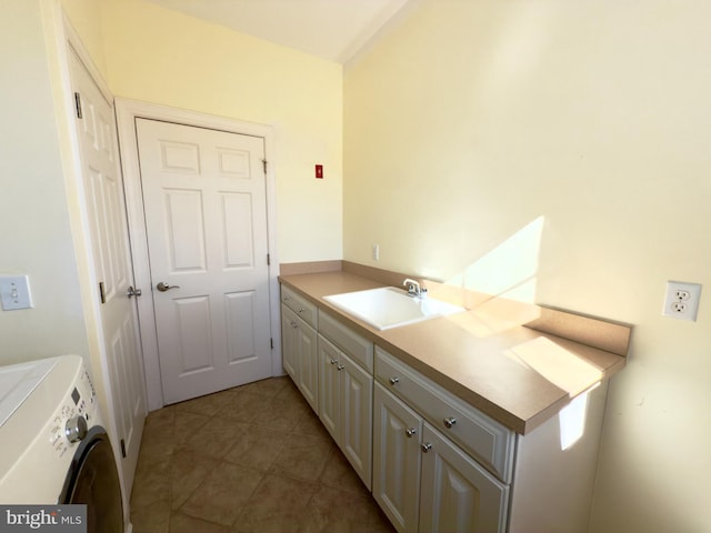 bathroom with vanity, tile patterned flooring, and washer and dryer