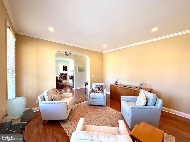 living room featuring wood-type flooring and ornamental molding