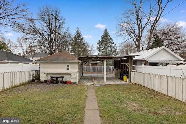 back of house with a patio and a lawn