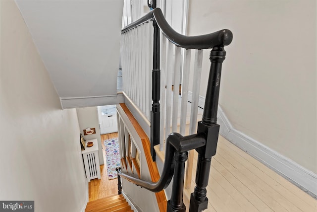 stairway with wood finished floors