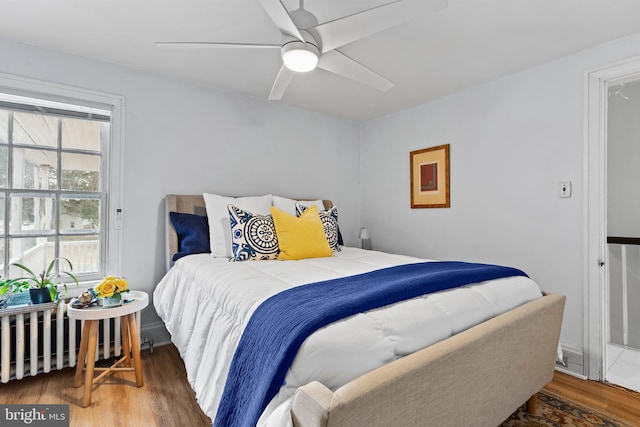 bedroom featuring dark wood-style flooring and ceiling fan