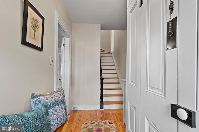 stairs featuring wood finished floors