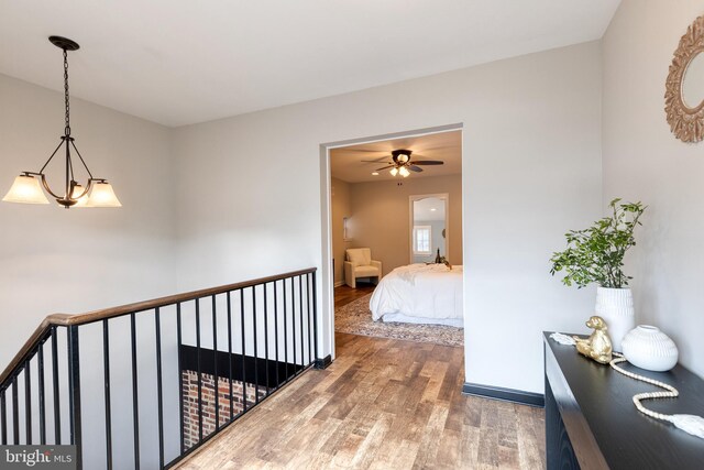 corridor featuring baseboards and wood finished floors