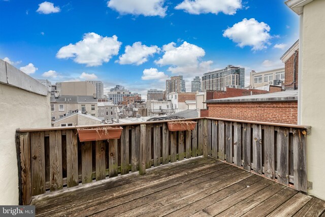 wooden terrace with a city view