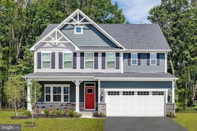 craftsman house with a garage and a front yard