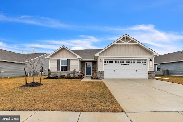 craftsman house with central AC unit, a garage, and a front lawn