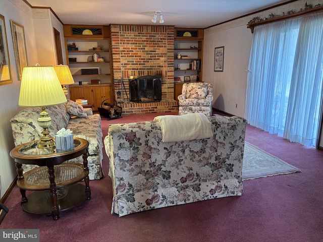 carpeted living room featuring a brick fireplace, built in shelves, and crown molding