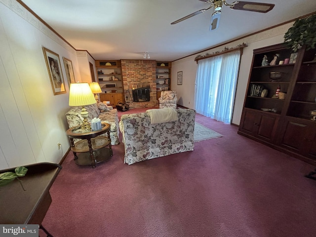 living area featuring built in features, a ceiling fan, ornamental molding, carpet floors, and a brick fireplace