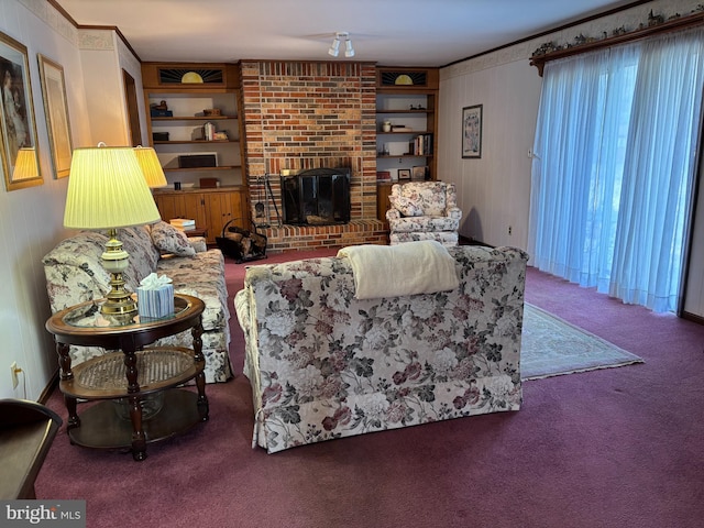 living room with carpet floors, ornamental molding, a fireplace, and built in shelves