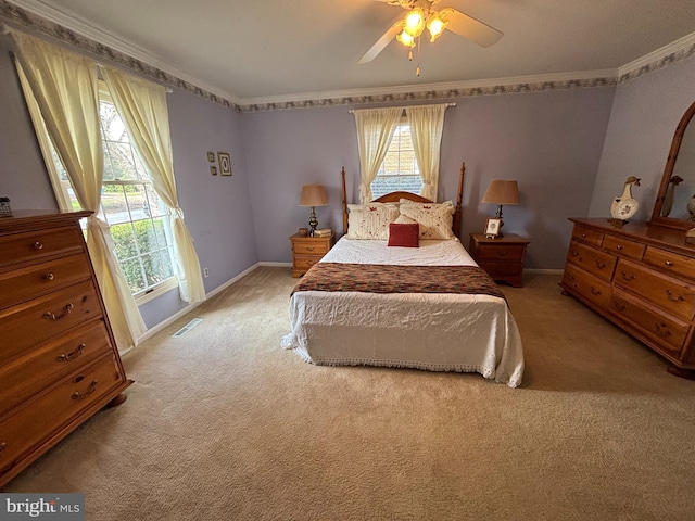 bedroom featuring baseboards, visible vents, crown molding, and light colored carpet