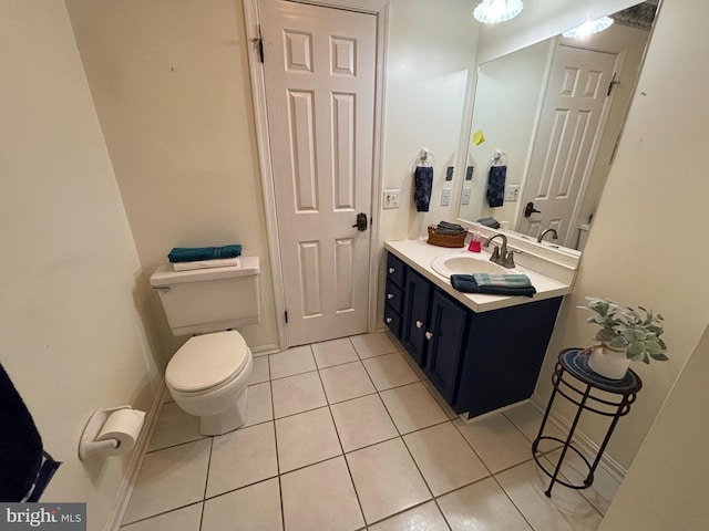 bathroom with vanity, toilet, and tile patterned floors