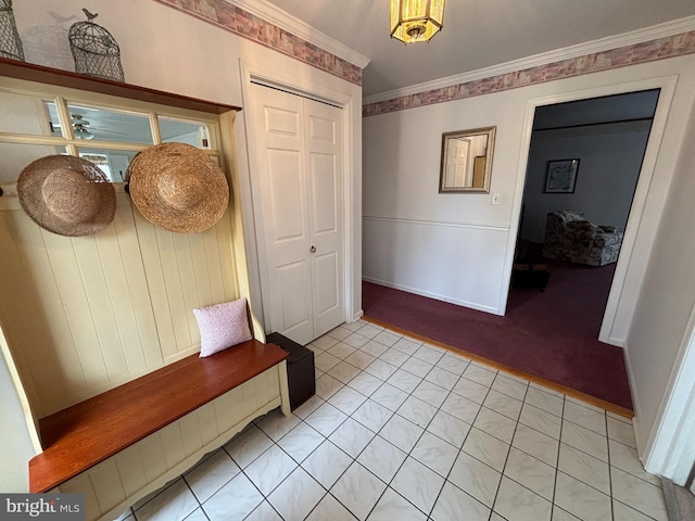 mudroom with ornamental molding and baseboards