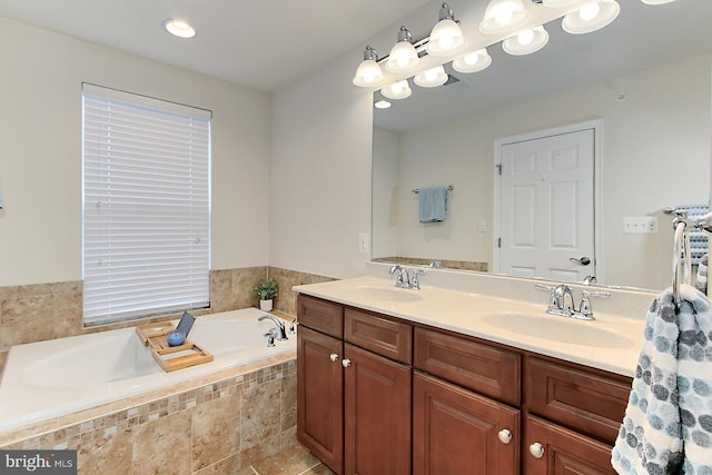 bathroom featuring vanity and a relaxing tiled tub