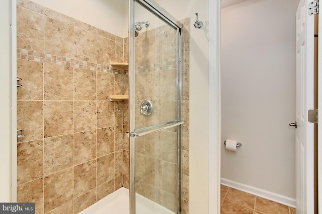 bathroom featuring tile patterned flooring and a shower with shower door