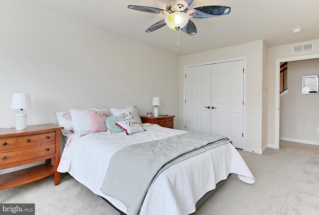 carpeted bedroom featuring a closet and ceiling fan