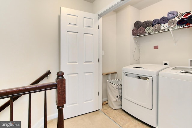 clothes washing area featuring washing machine and clothes dryer