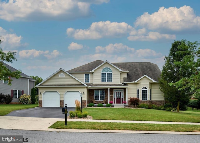 traditional-style home featuring a garage, stone siding, aphalt driveway, and a front yard