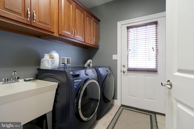 laundry room with cabinet space, light tile patterned floors, a sink, and independent washer and dryer