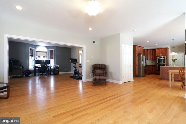 living area featuring baseboards, recessed lighting, visible vents, and light wood-style floors