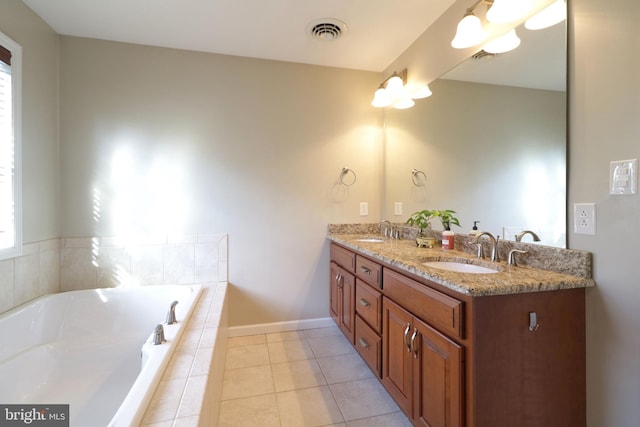 bathroom featuring double vanity, tile patterned flooring, visible vents, and a sink