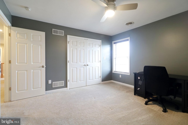 office featuring baseboards, visible vents, and light colored carpet