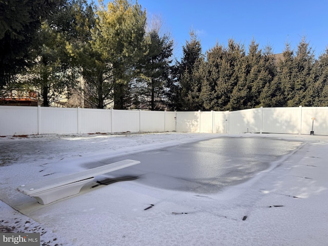 view of swimming pool featuring fence