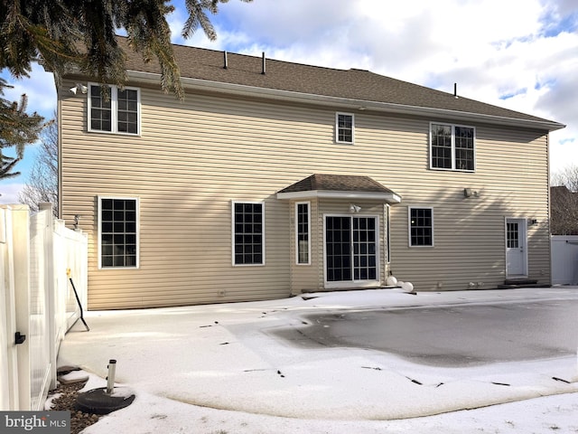 rear view of property with fence